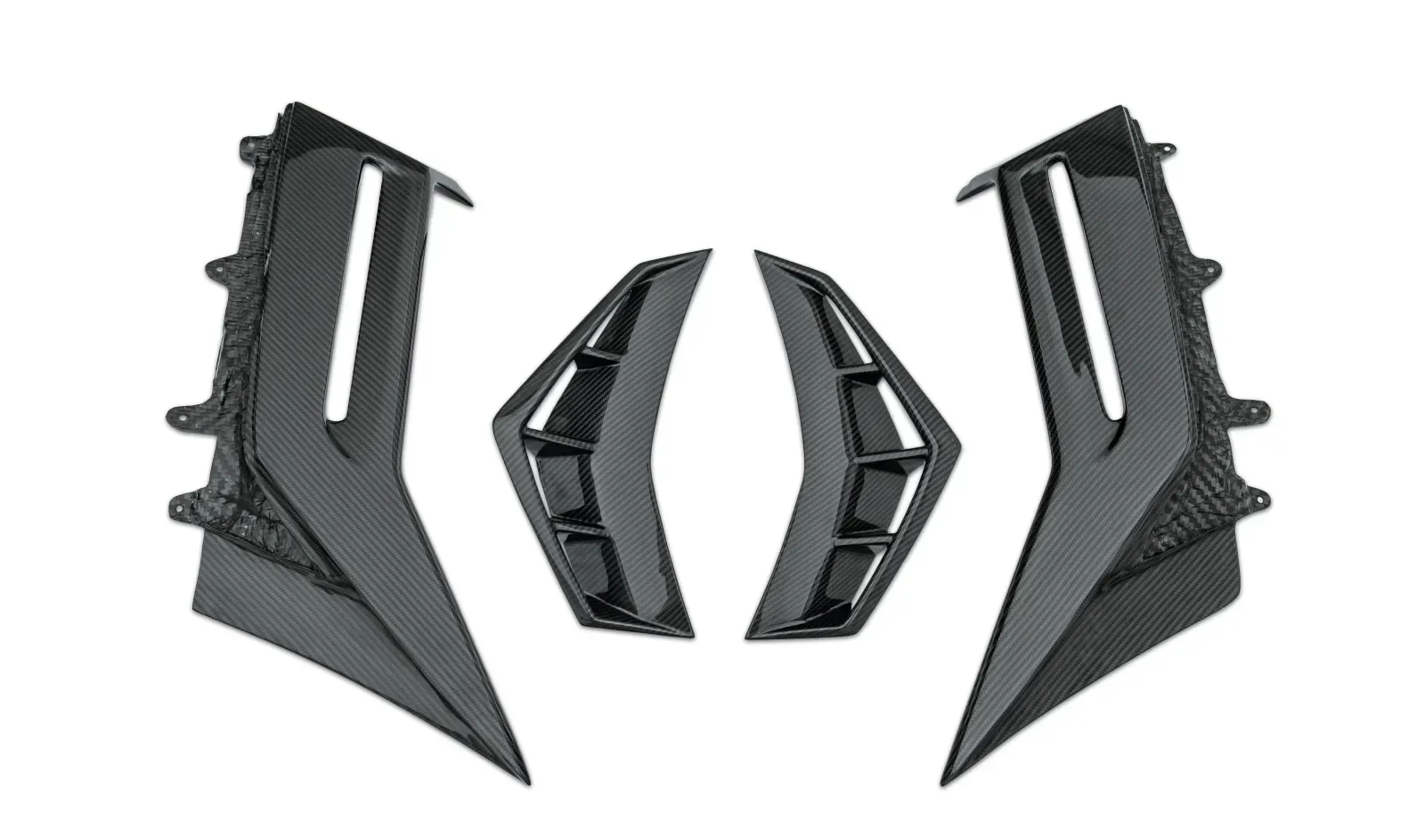 Four carbon vented fender and quarter-panel inserts on a white studio background, weave and mounting tabs visible