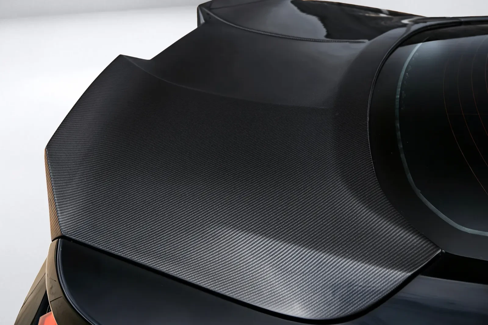 Exposed twill carbon weave under a gloss clear coat on a fitted ducktail spoiler