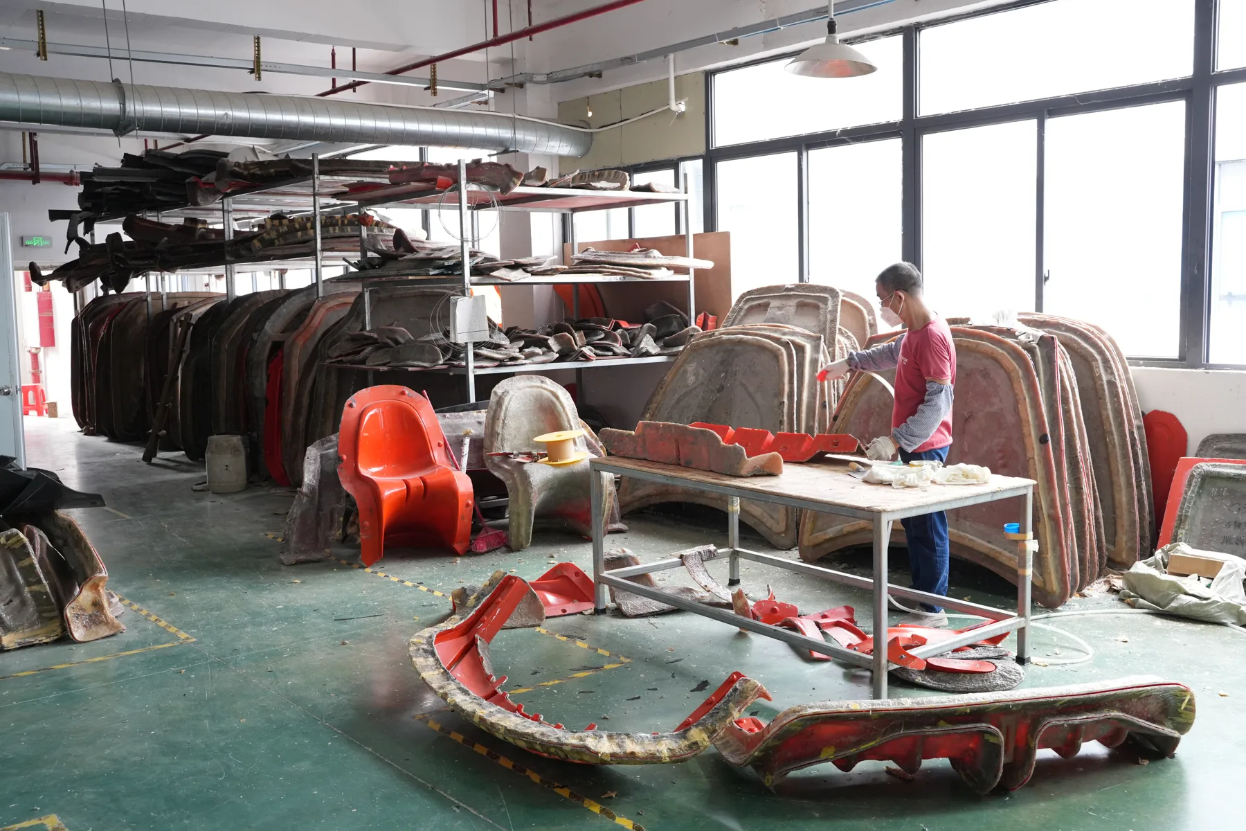 Rows of composite molds stored on racks inside the factory